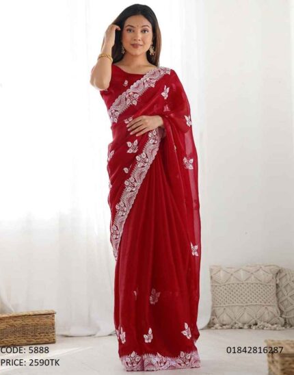 A woman wearing a gorgeous red soft georgette saree with intricate white embroidery and sequence work on the border.