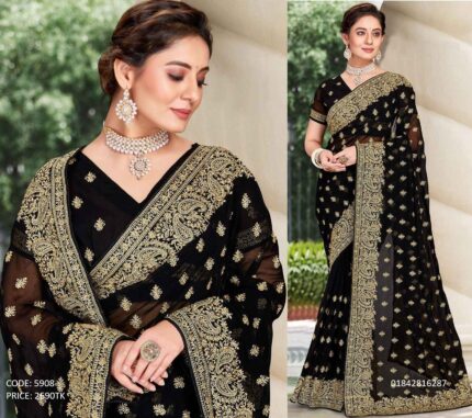 A woman wearing a premium black soft georgette saree featuring intricate golden embroidery and sequence work all over the body and border, paired with traditional jewelry.